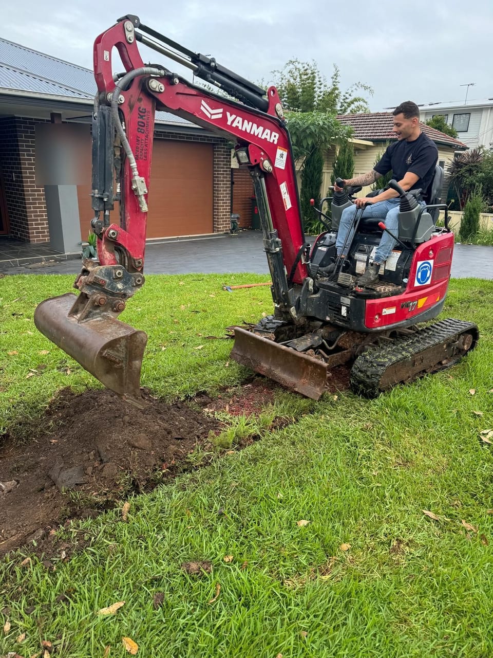 Aurum Built operator using a mini excavator for earthworks on a Sydney property