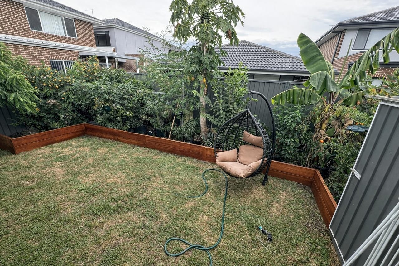 Timber retaining walls and raised garden beds around a landscaped Sydney backyard